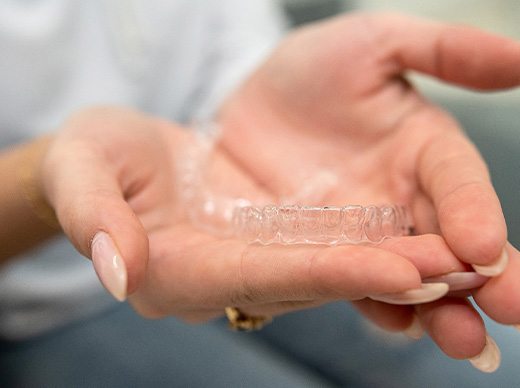 Patient holding clear aligners