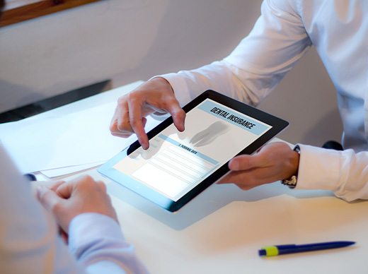 Patient reviewing dental insurance form on tablet