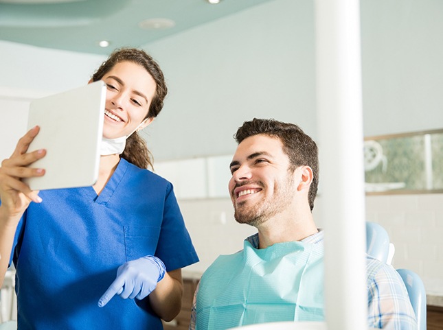 Dentist discusses something with patient