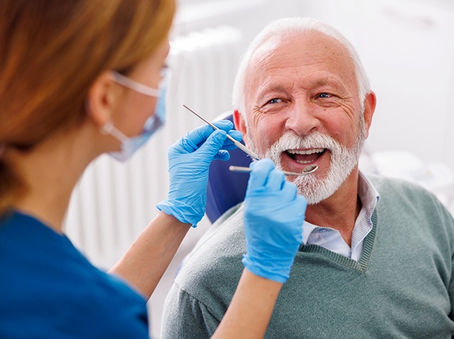 Man smiles at dentist