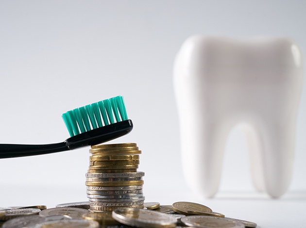 Front desk smiling as they help patient with dental insurance