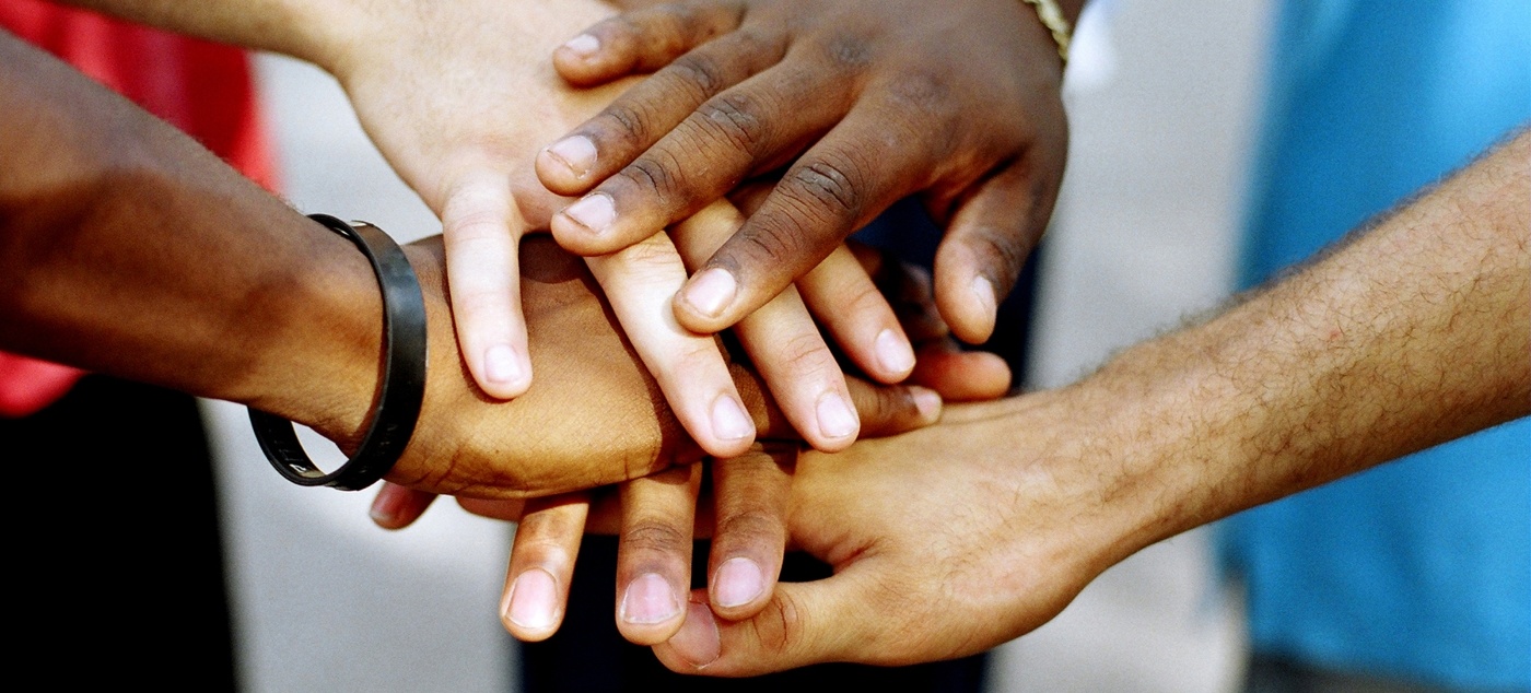 Group of people putting their hands together