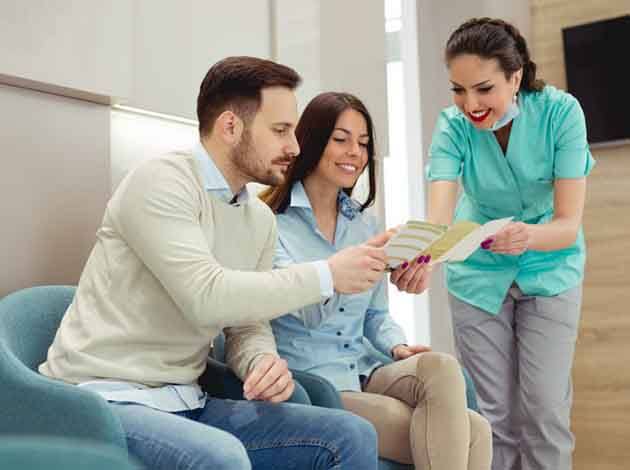 patients speaking with a front desk team member