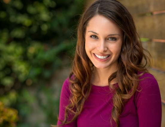 Woman in fuschia blouse smiling