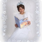 Woman dressed as the tooth fairy reading a book