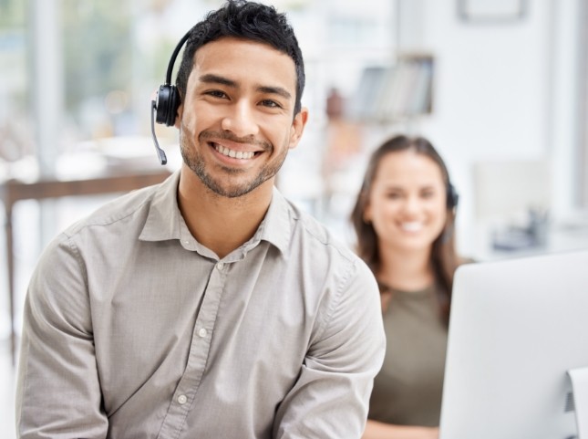 Smiling man in office wearing headset