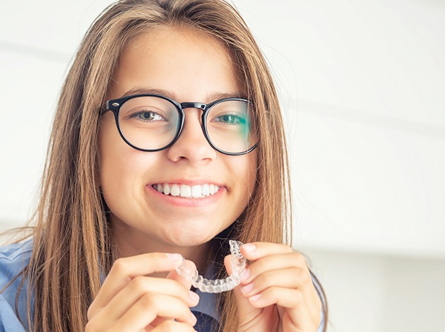 Patient holding clear aligner