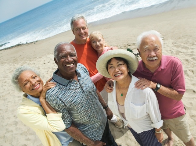 Smiling group of seniors on a beach