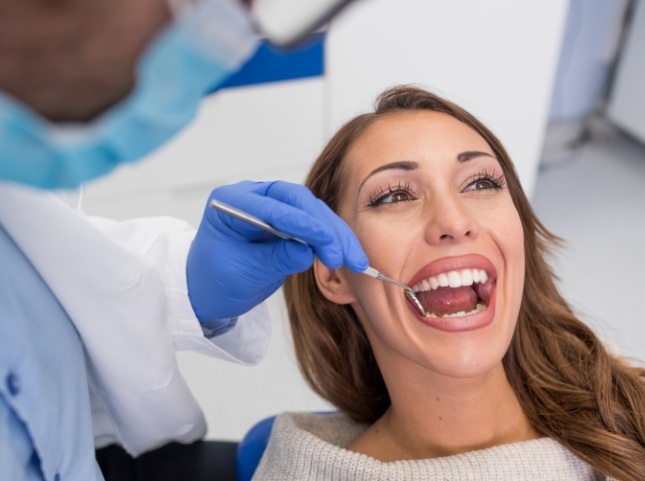 Woman opening her mouth during dental checkup