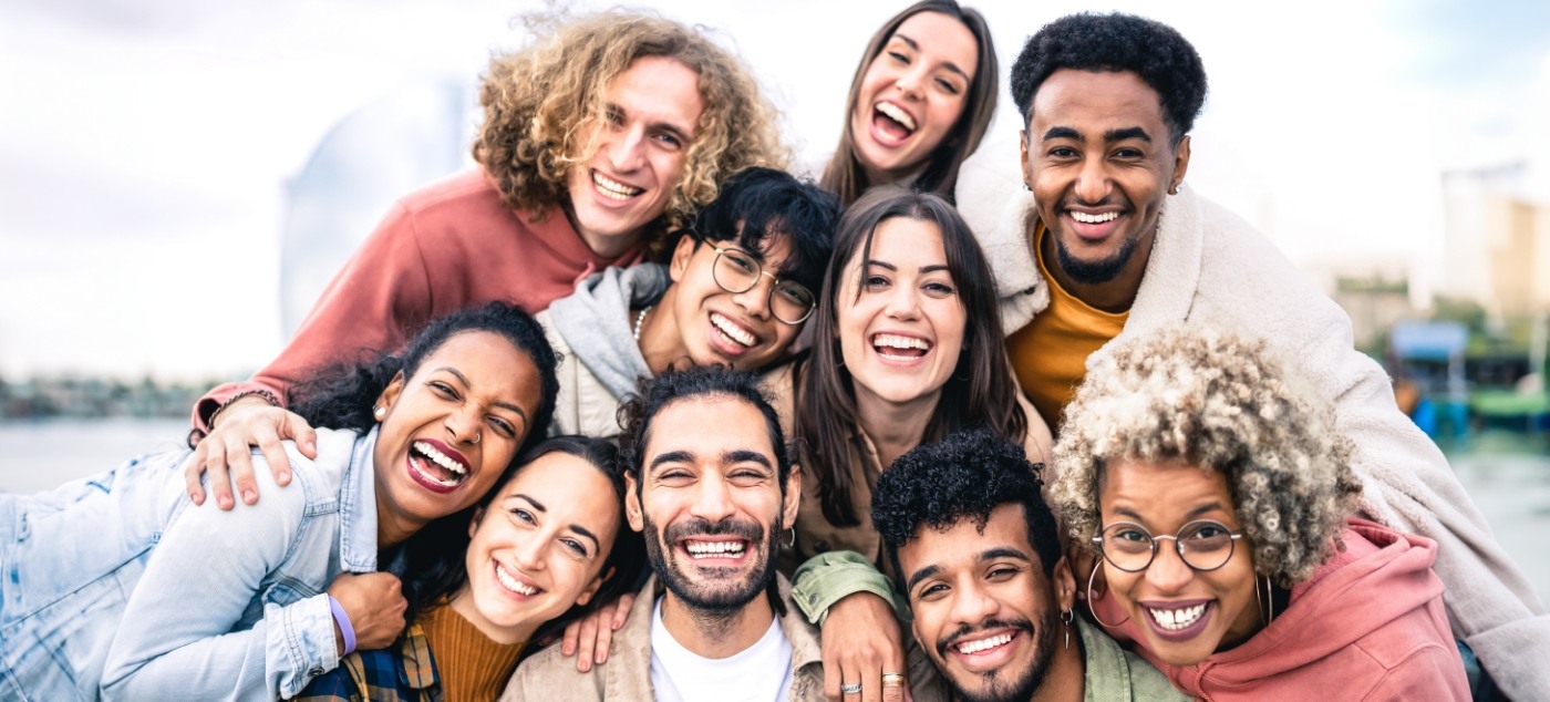 Ten people smiling together