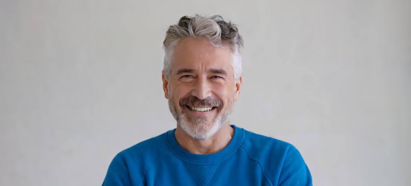 Smiling senior man wearing blue sweatshirt