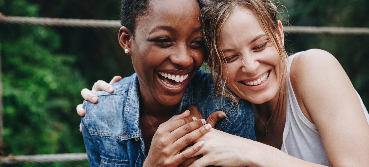 Two young women smiling together