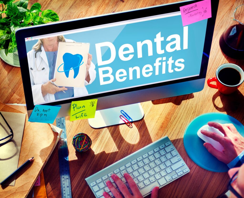 Someone at computer looking at dental benefits
